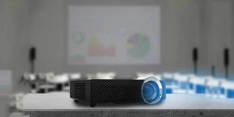 Modern video projector and blurred conference room on background