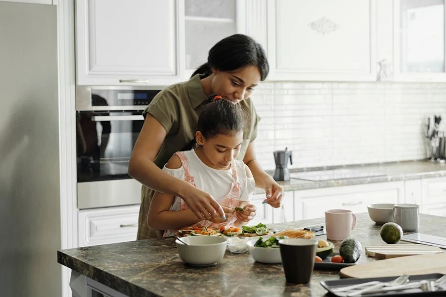 Mother and daughter cooking on a granite countertop