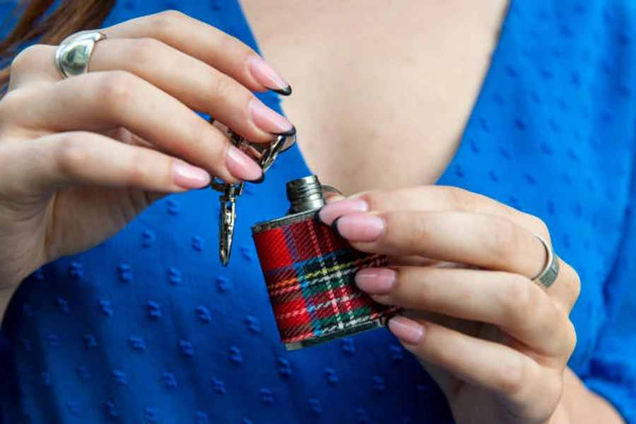 Pair of Hands Holding a Tartan Hip Flask