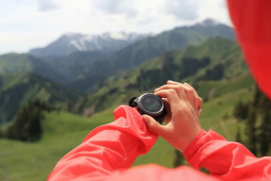 Person checking their smartwatch while hiking