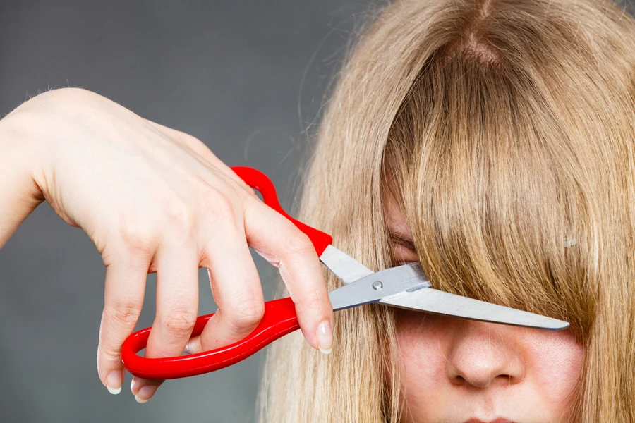 Person cutting bangs