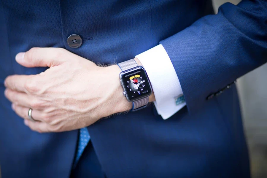 Person in a suit wearing an Apple Watch