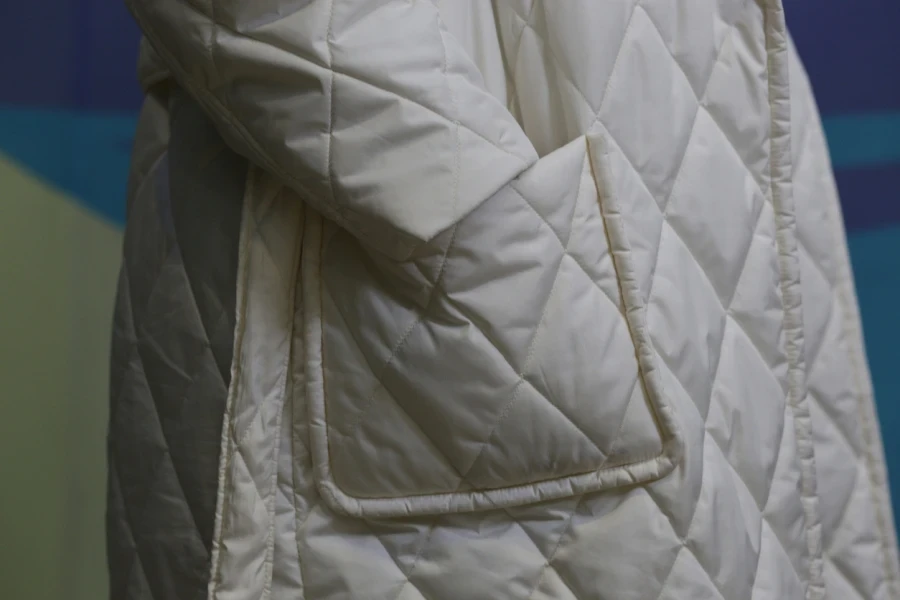 Person rocking a white quilted trench coat