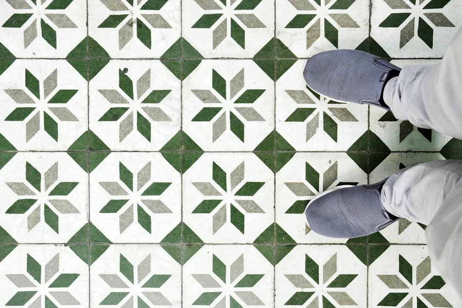 Person standing on bright geometric floor tiles