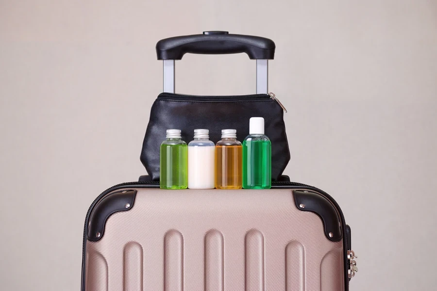 Shampoo bottles displayed on a travel suitcase