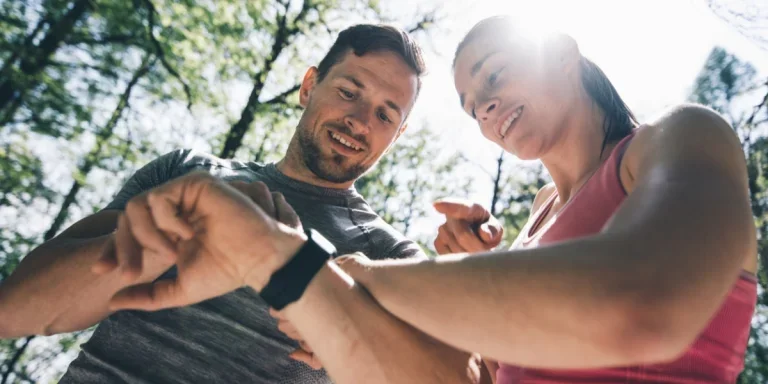 Two people comparing their smartwatches