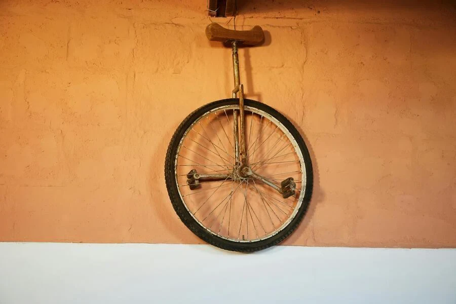 Unicycle hand on a brown brick wall