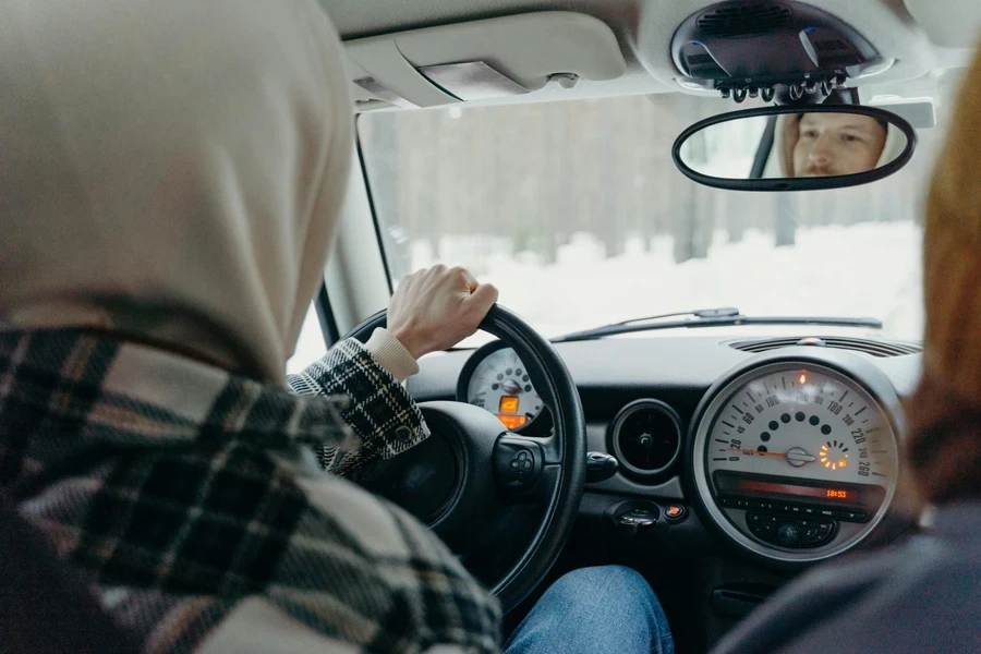 View of a Man Driving a Car in a Forest in Winter