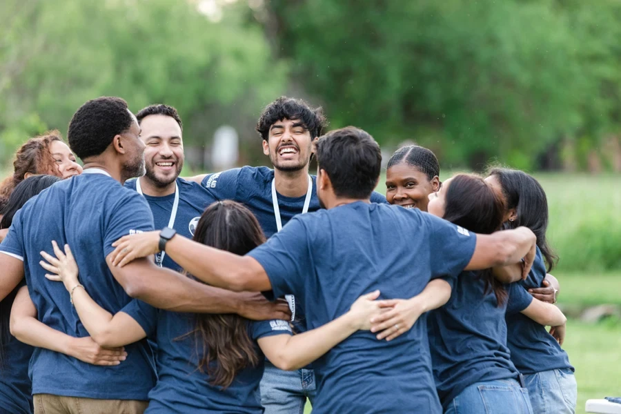 Volunteers for a non-profit organization hugging each other