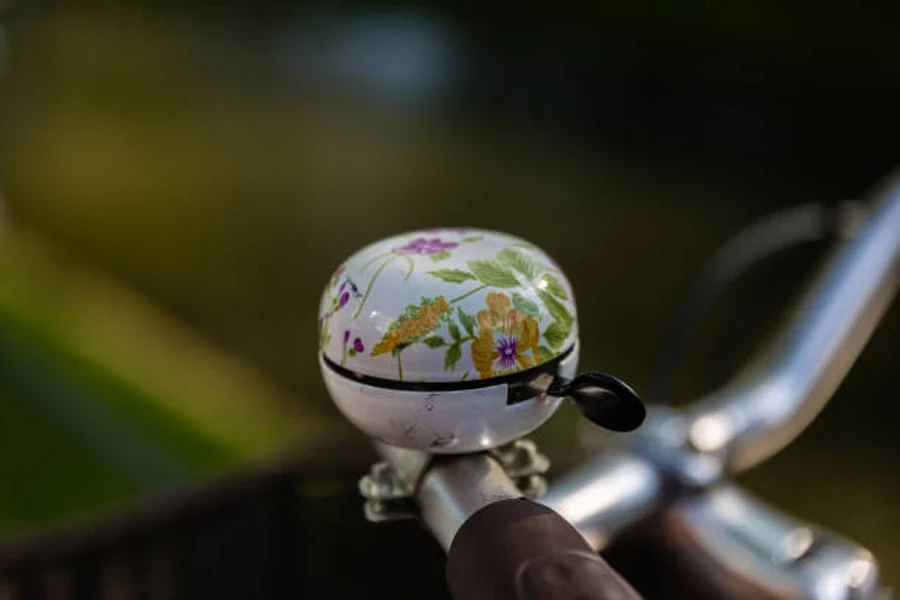 White bell with flower pattern on bike’s handlebar