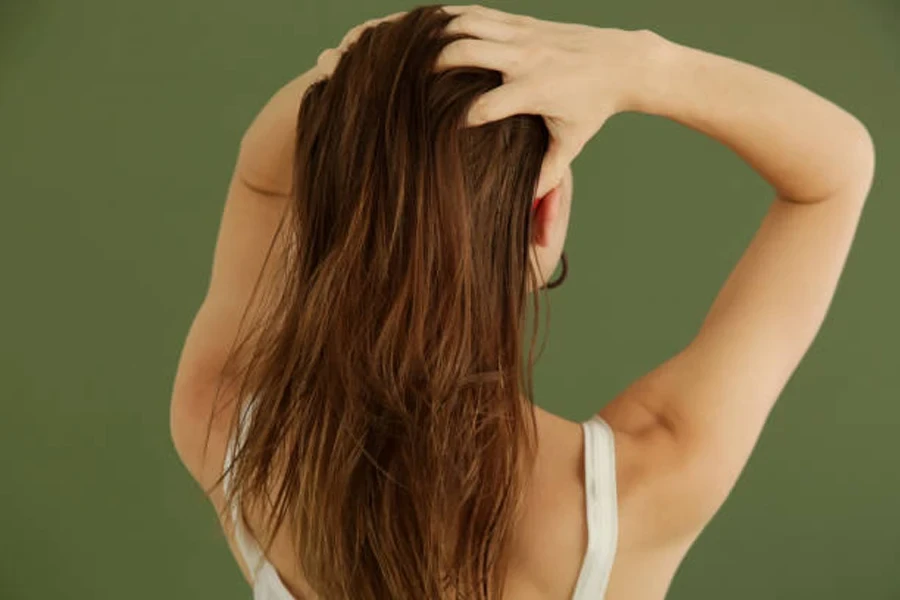 Woman Applying Hair Oil