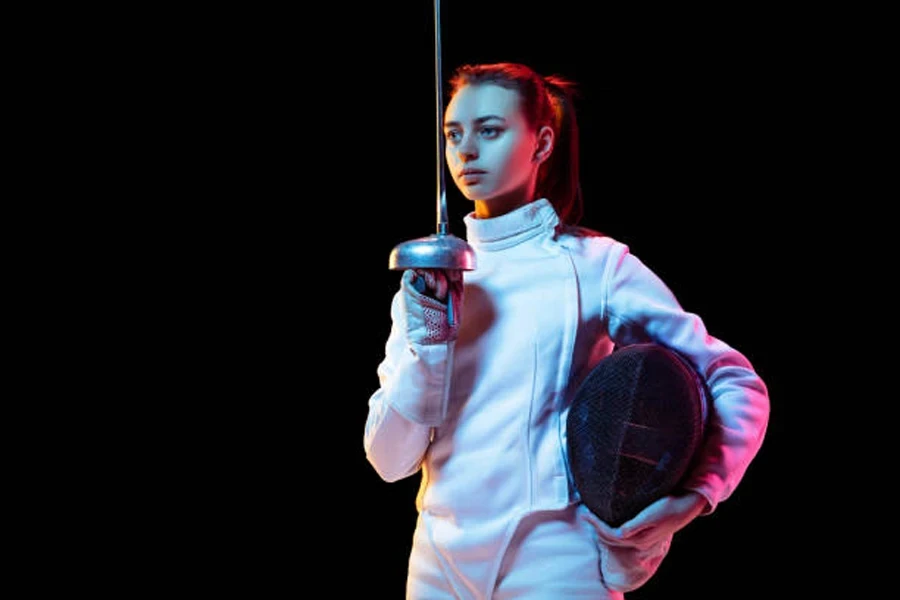 Woman fencing sword while wearing fencing products