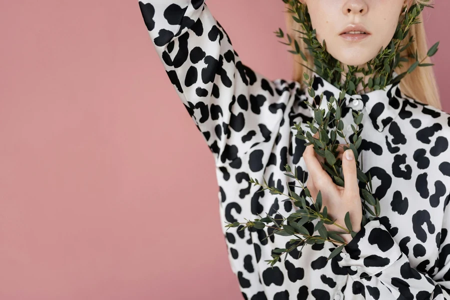 Woman in black and white cowhide print blouse