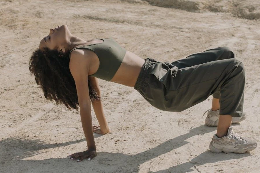 Woman in posing in high-waisted joggers during the day