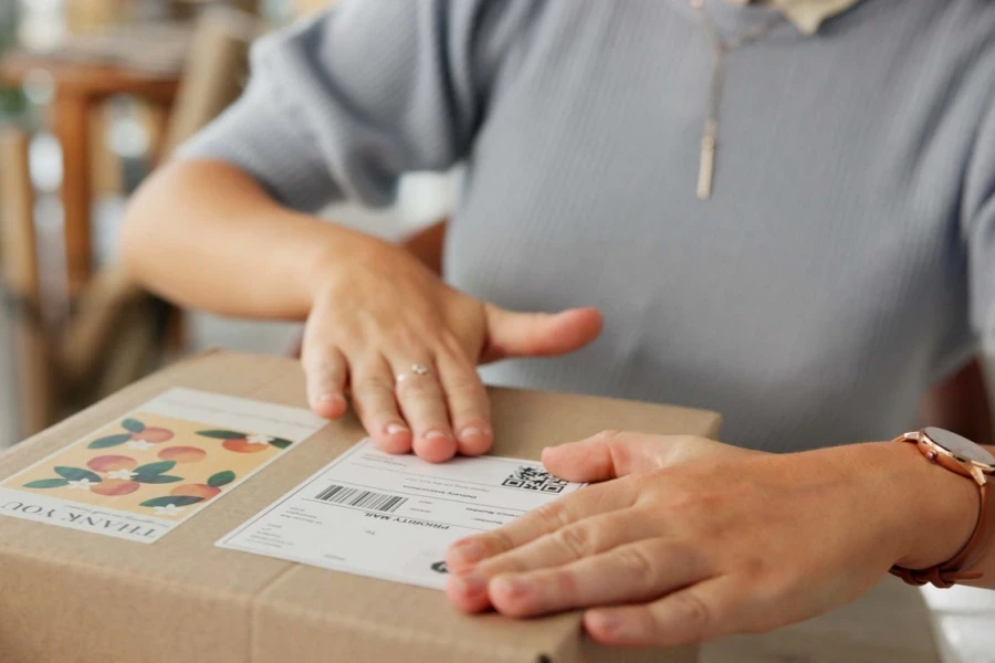 Woman placing a delivery label on a package