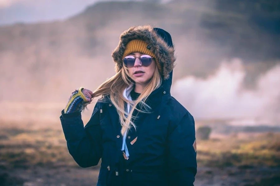 Woman posing in a stylish blue parka