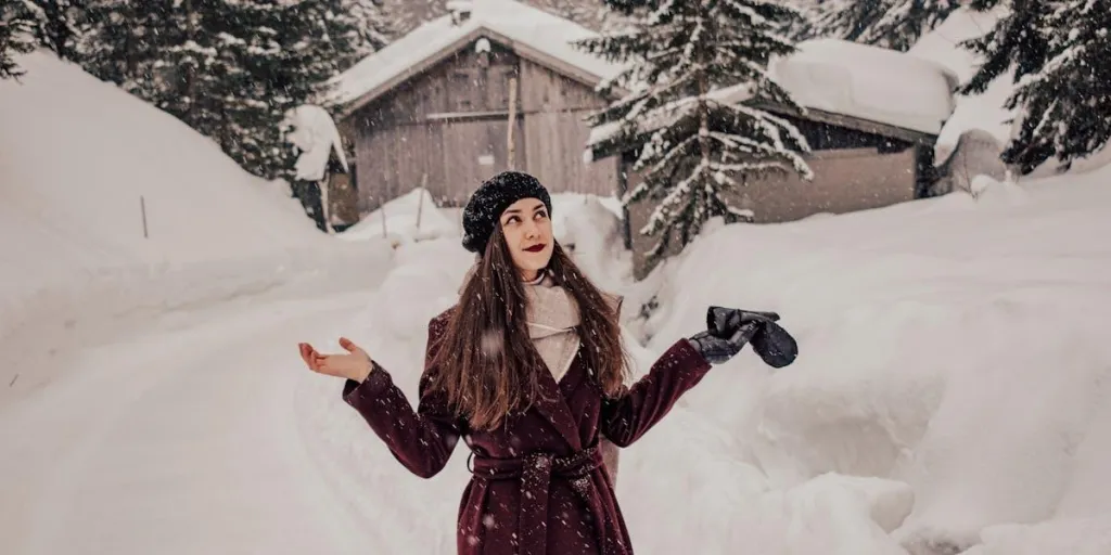 Woman posing in a winter coat in the snow