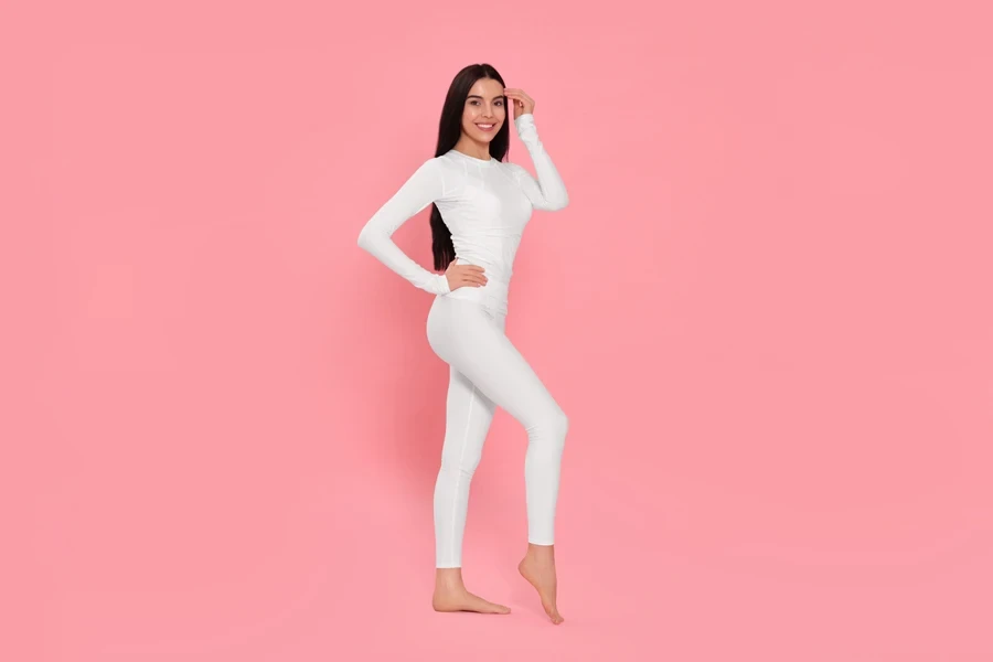 Woman posing in white thermal leggings and top