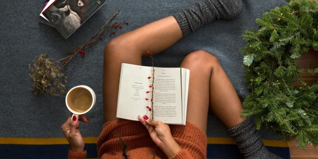 Woman sitting on a Ruggable rug reading a book