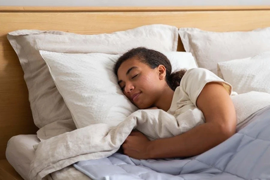 Woman sleeping on comfortable white pillows