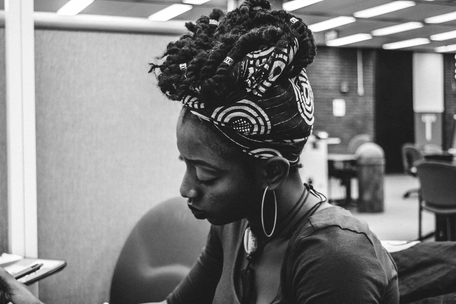 Woman wearing black and white shirt and headscarf