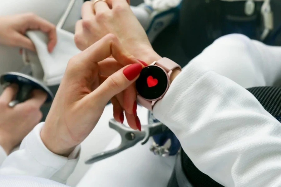 Woman wearing smartwatch with a heart on the screen