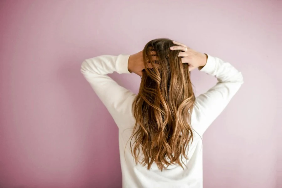 Woman wearing white holding her hair