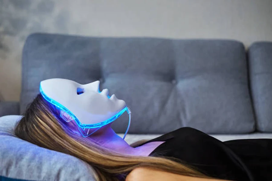 Woman with LED Light Therapy Facial Beauty Mask