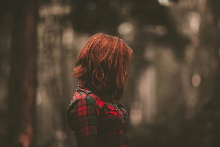 Woman with red hair over face