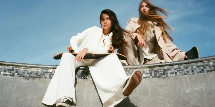 Women in White Coat Holding a Skateboard