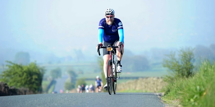 a man riding a bike down a road