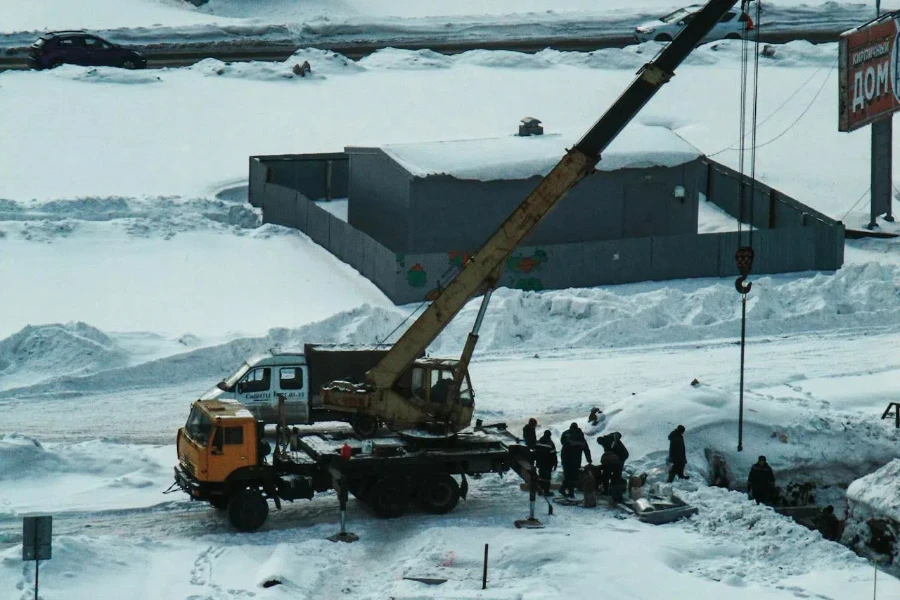 A medium duty boom truck at work in winter