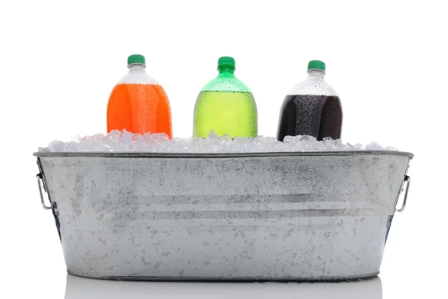 A metal beverage tub with three soda bottles