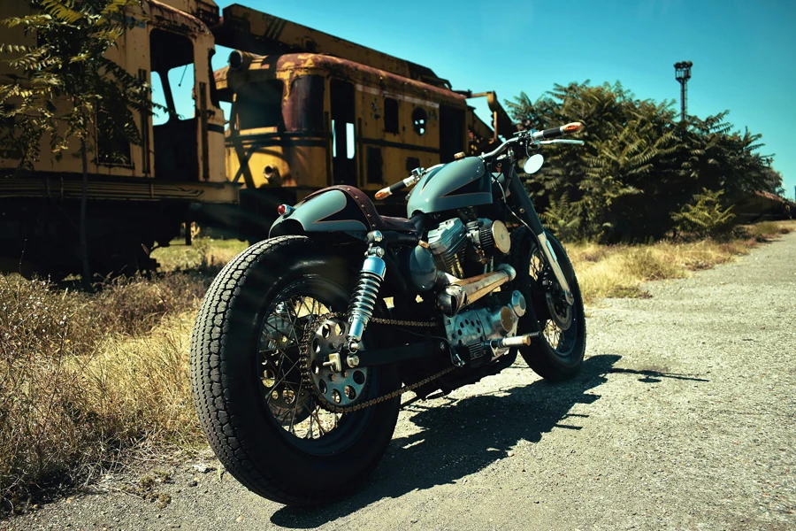 a motorcycle parked in front of a train