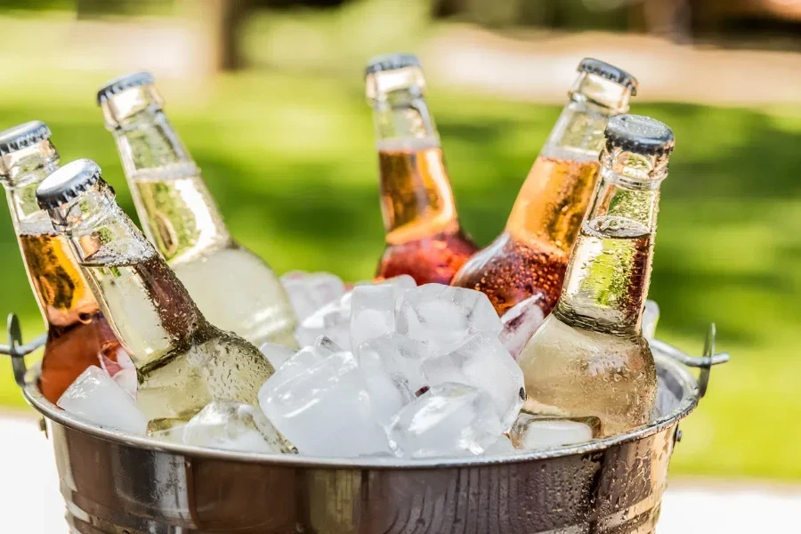 A steel ice bucket filled with chilled drinks