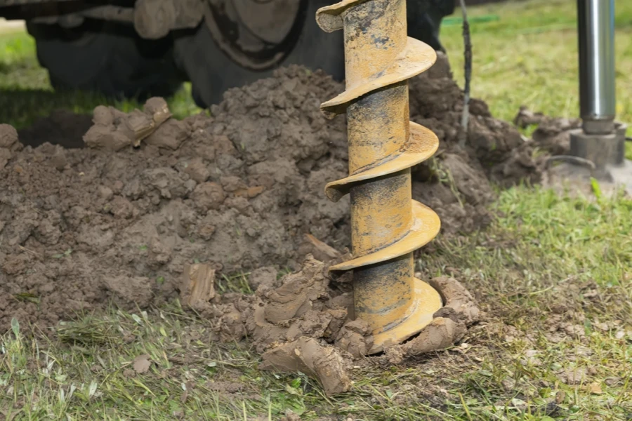 a well drill driving into the ground