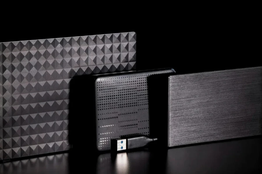 Multiple external hard drives on a black surface