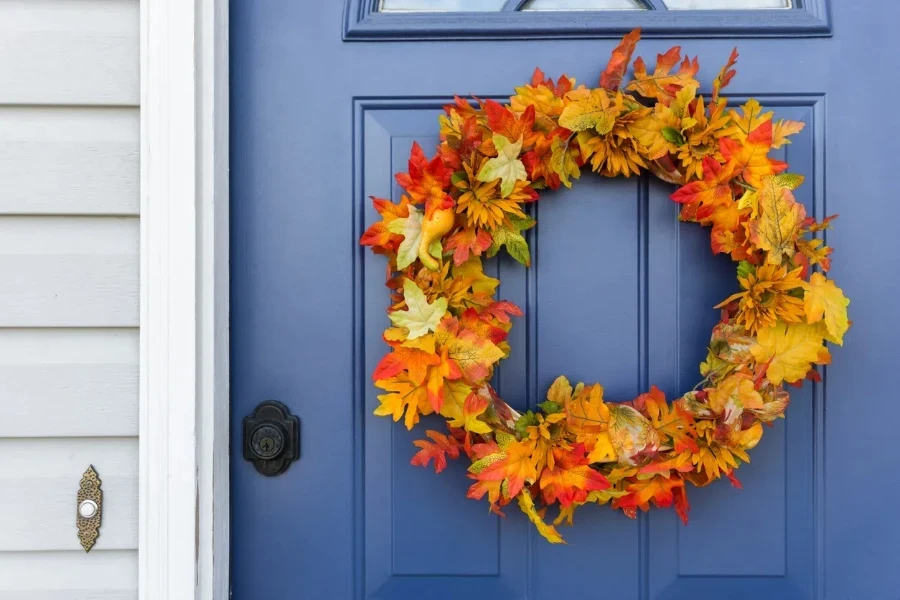 orange and yellow autumn wreath on blue door