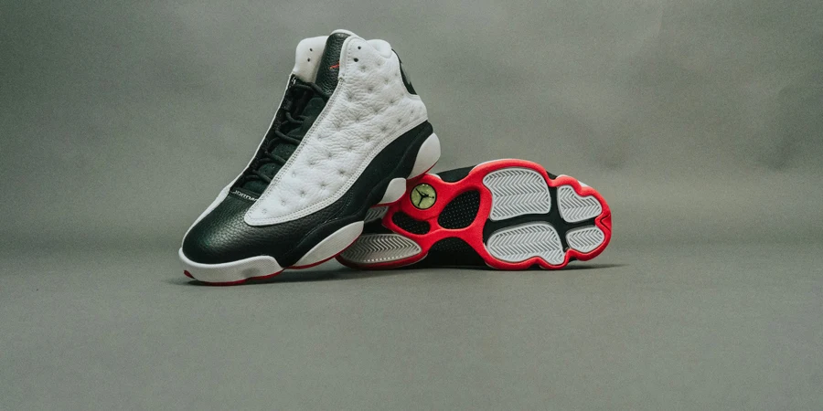 pair of black-and-white Air Jordan 13 shoes on gray surface