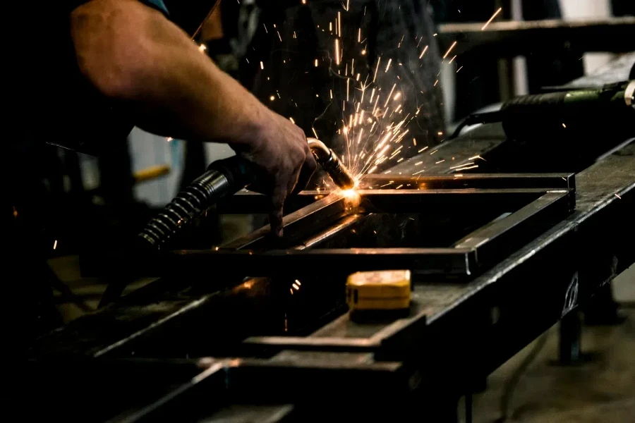 Person welding a steel construct