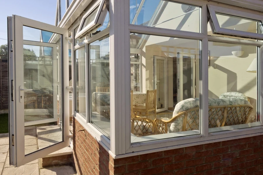 sunroom with windows and a door