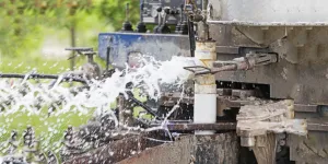 water flowing from a water well drill