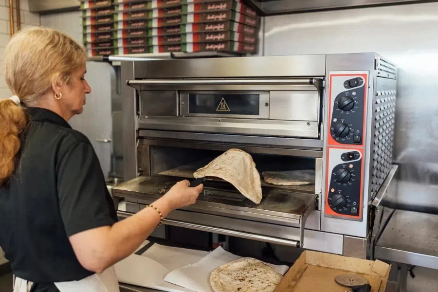 Woman placing tortilla in a machine