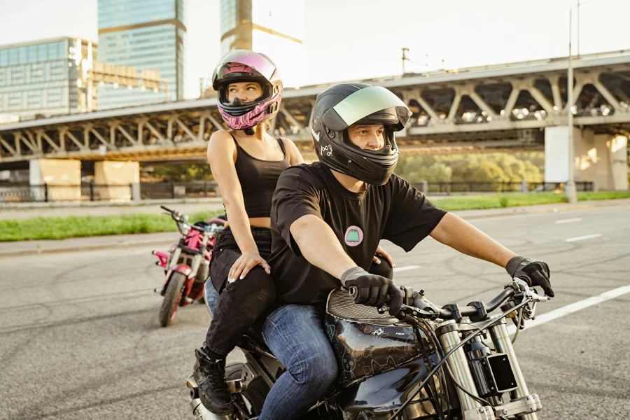 A Couple with Helmets Riding Motorbike