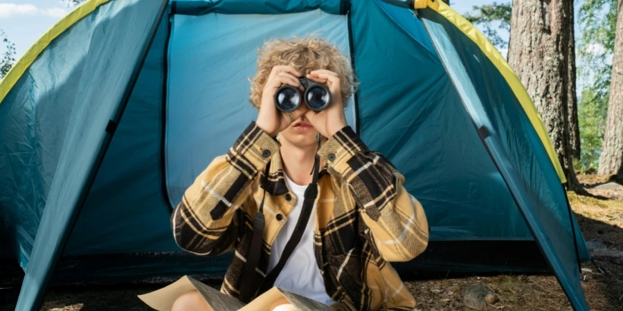 A Teenager Looking Through the Binoculars