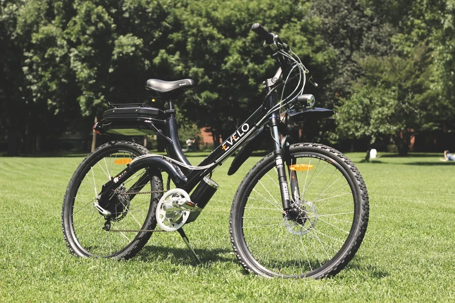 A black and white electric bike sitting in the grass