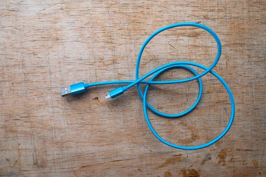 A blue wire on a wood surface