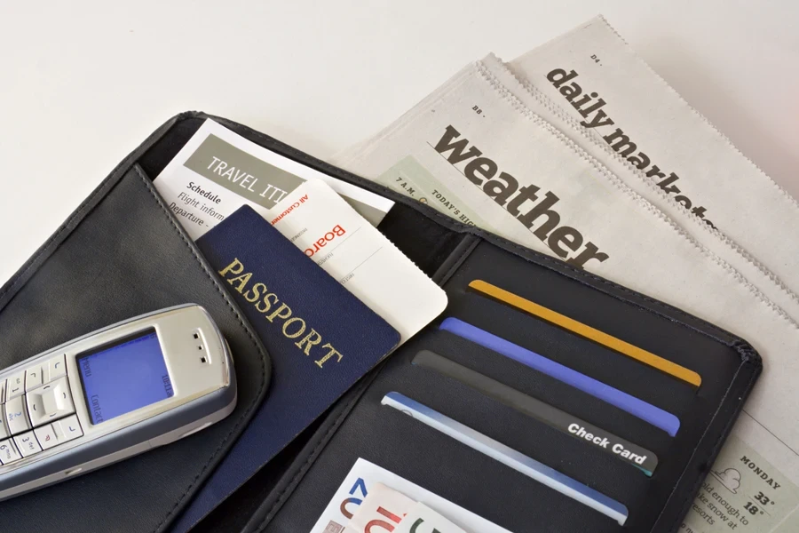 A business travel wallet with passport on newspapers