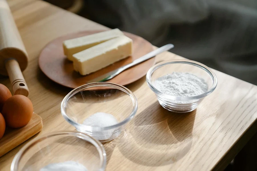 A butter knife next to some butter sticks