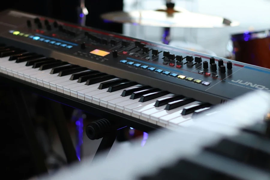 A close-up shot of a Roland Juno synthesizer keyboard in a music studio, showcasing its detailed control panel and keys